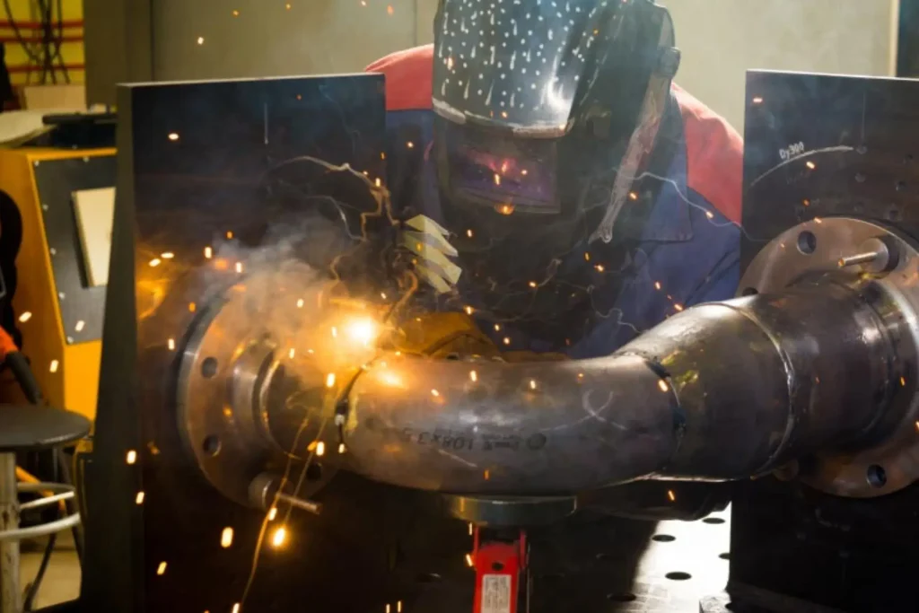 Student performing pipe welding during a boilermaker course practical session at Wheelset Academy.