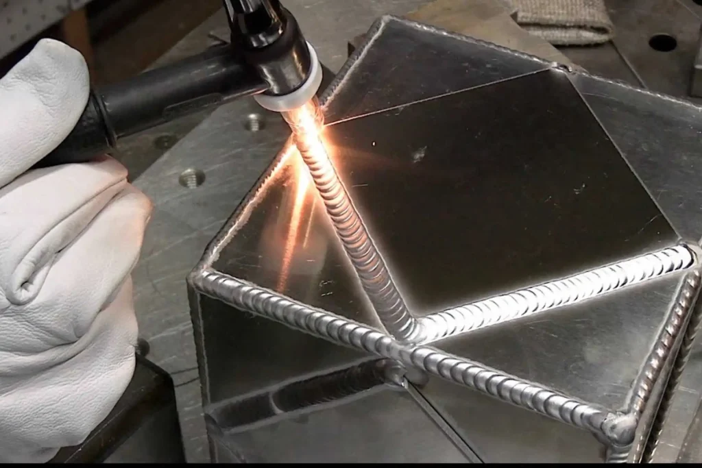 Welder completing an aluminium weld joint during welding short courses at Wheelset Academy.