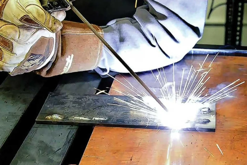Welder using stick electrode in arc welding practical training during welding short courses at Wheelset Academy.