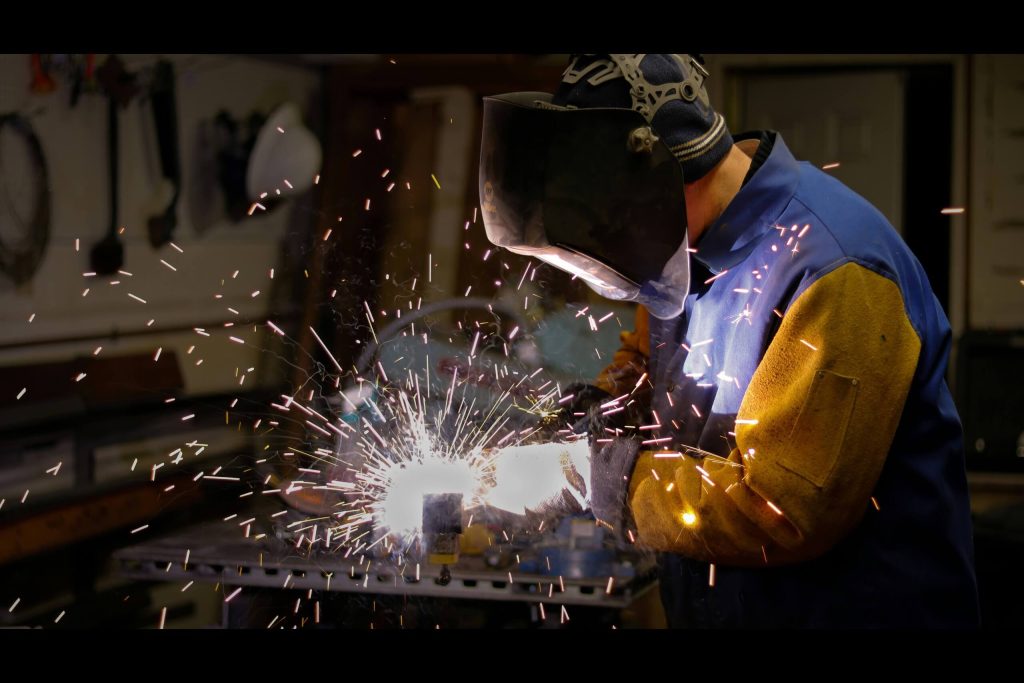 Student welding metal during a boilermaker course practical session preparing for a boilermaker apprenticeship and boilermaker trade test.