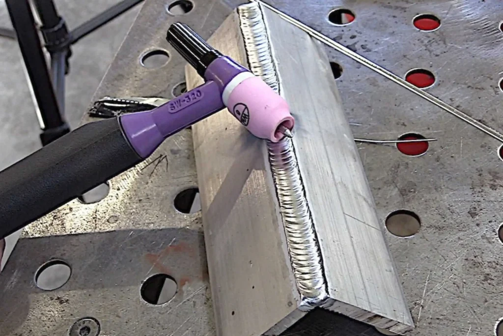 TIG torch positioned on a clean weld joint during welding short courses at Wheelset Academy.