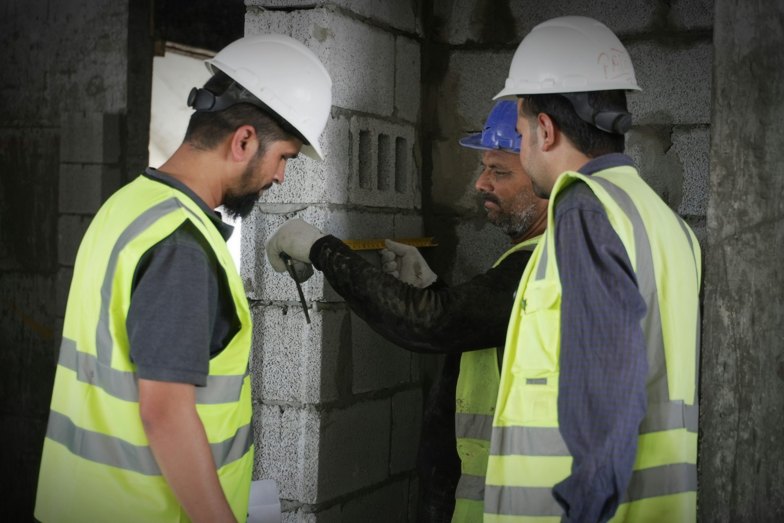 Builder's Worker course learner mixing mortar and wearing PPE at Wheelset Academy
