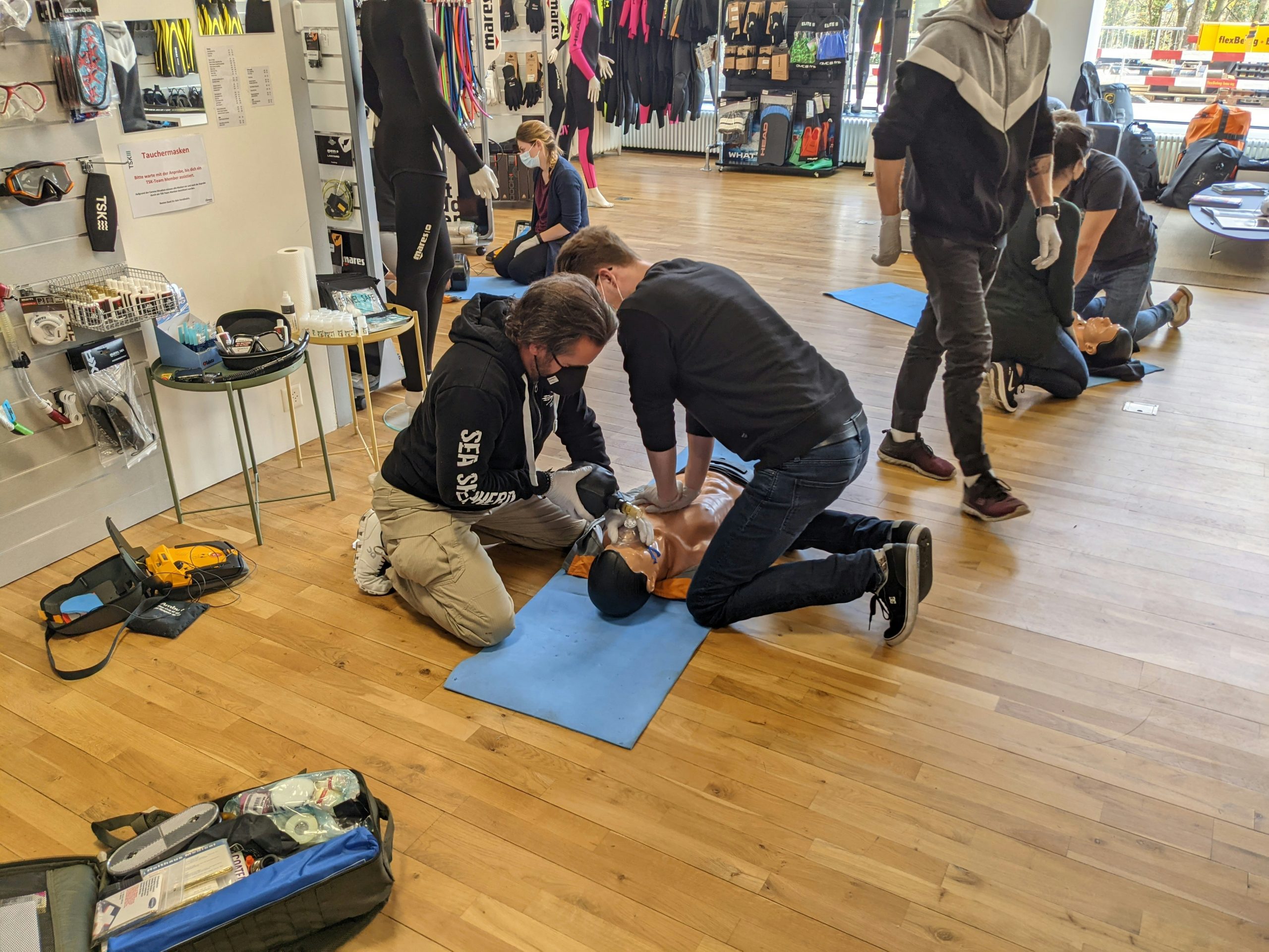 Basic emergency first aid responder learner practising CPR on a training manikin at Wheelset Academy
