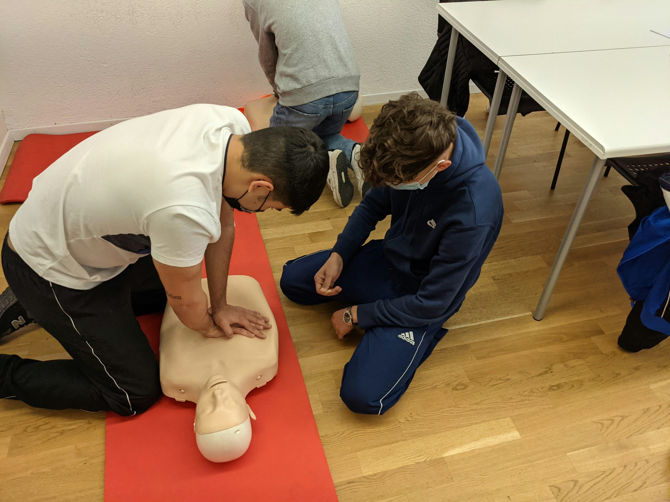 Intermediate Emergency First Aid Responder learner practising CPR on a training manikin at Wheelset Academy